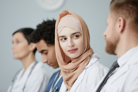 Portrait of young Muslim woman wearing headscarf in audience at medical seminar, copy space