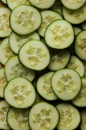 Top view of fresh cucumber slices as abstract food background, copy spaceの写真素材