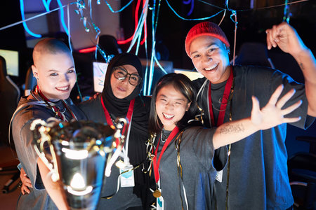 Multi Ethnic team of young women as professional gamers celebrating victory in eSports championshipの写真素材