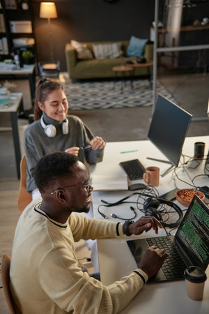 Young developers laughing and joking around when working on project in office