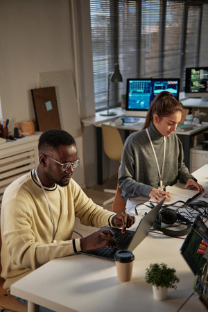 Young developers working in small office of IT companyの写真素材