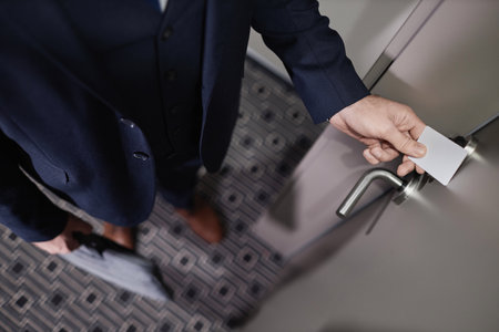 Top view closeup of businessman opening hotel room door with contactless key card, copy spaceの写真素材