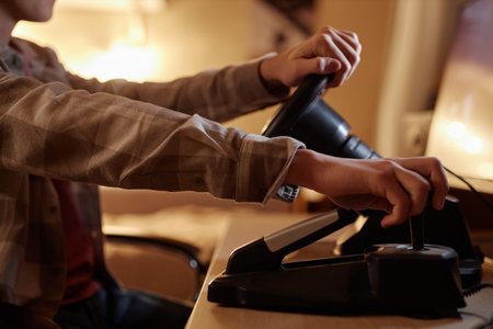 Close up of teenage boy playing racing simulator videogame and shifting gears, copy space