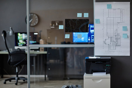 Background image of glass wall in security department with building plans and maps copy spaceの写真素材