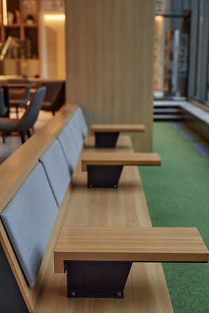 Vertical background image of seating row facing window with geometric details in office building or...