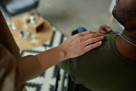 Close up of caring female therapist laying hand on shoulder of army veteran during support session on mental health copy spaceの写真素材