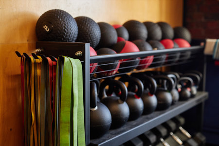 Background image of equipment rack in gym with medballs kettlebells and weights copy spaceの写真素材