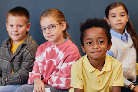 Portrait of multiethnic group of young children looking at camera together with focus on African American boy in foreground copy spaceの写真素材