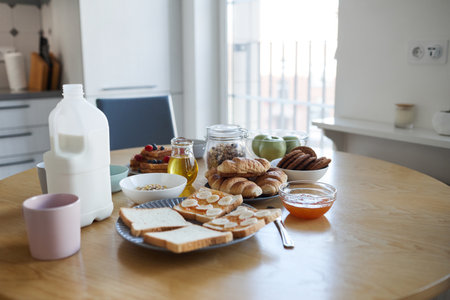 Background image of simple homemade breakfast with milk and sandwiches on wooden table in cozy...