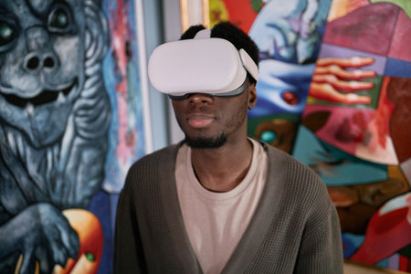 Man using VR headset surrounded by colorful street art murals depicting abstract forms immersive experience blending technology and creativityの写真素材