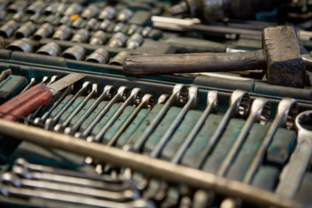 Close-up of various tools, including wrenches and hammers, neatly arranged in a toolbox, showing attention to detail and preparedness for mechanical workの写真素材