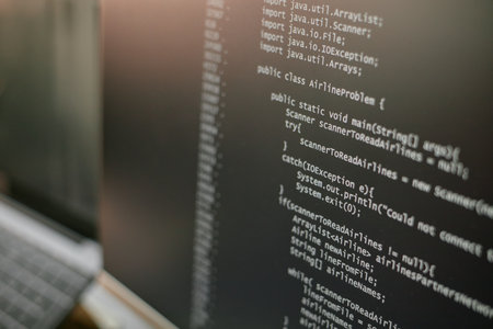Close up showing computer monitor displaying Java programming code with public class and exception...