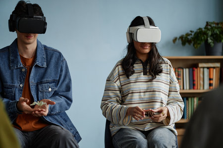 Multiethnic teenagers wearing virtual reality headsets participating in counseling session, sitting...
