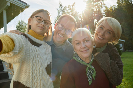 Portrait of Caucasian teenager girl taking selfie with middle aged Caucasian man, senior Caucasian...