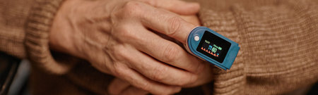 Website header shot of senior Caucasian woman holding pulse oximeter on finger checking blood oxygen...