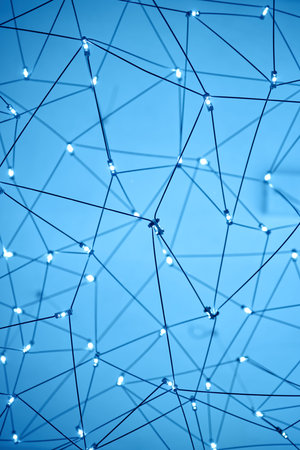 Network of interconnected wires with glowing points forming geometric pattern on blue background...