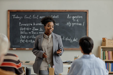 Black woman young adult standing in front of classroom teaching diverse group of adults, gesturing...