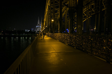 Cologne Cathedral and Hohenzollern Bridge at nightの写真素材