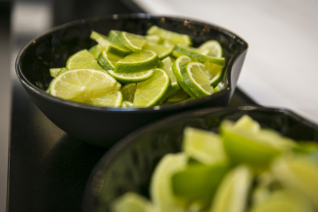 Bowl of limes on a bar counterの写真素材