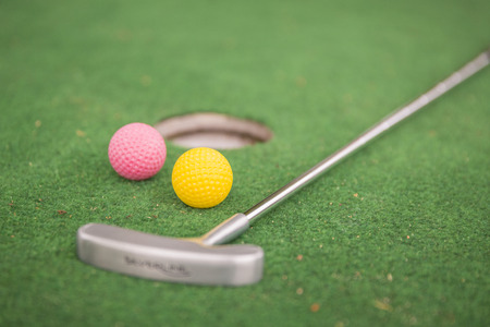 Mini golf with balls, racket and hole