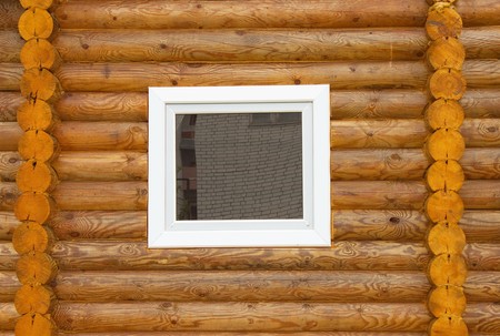 Plastic window is inserted into a wooden wallの写真素材