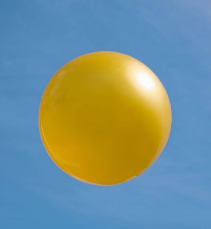Ball of golden colour against the skyの写真素材