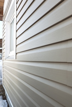 Wall of the house, finished in vinyl siding and windowの写真素材