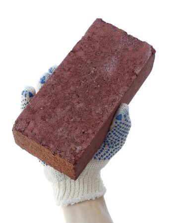 A small concrete block in the hand of the builderの写真素材