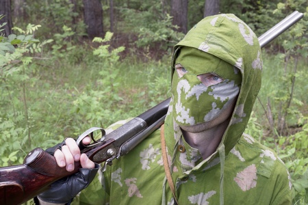 The shooter in camouflage with an old gunの写真素材