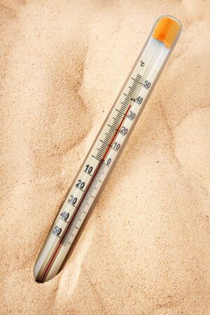 Thermometer shows the intense heating of the sandの写真素材