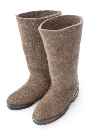 Old felt boots with rubber soles on snowの写真素材