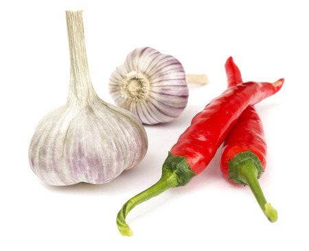 Pepper and garlic lie on white の写真素材