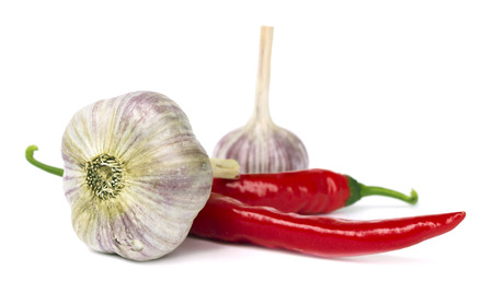 Red pepper and garlic lie on white background の写真素材