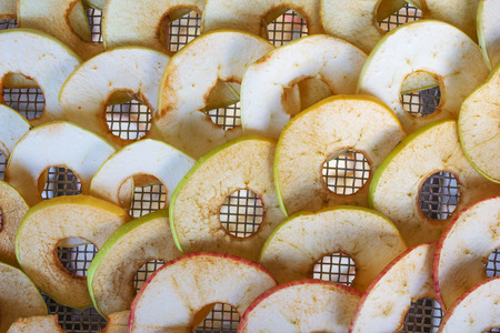 Apples are put on the grate dryerの写真素材