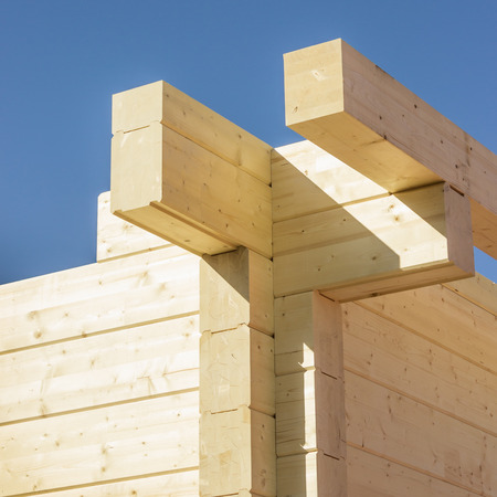 Construction of a building made of glued beams. Angle of log house