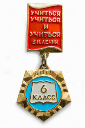 Moscow, Russia - Mar 26, 2020.: Soviet badge of school student. Inscription: Learn to learn and learn. V.I. Lenin. On suspension inscription: 6th gradeのeditorial素材