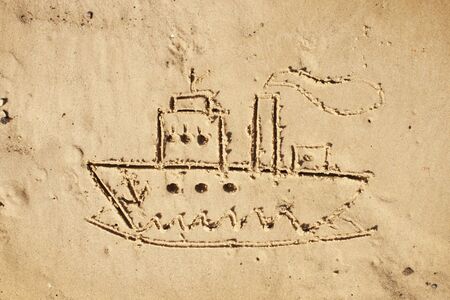 Steamer was depicted in the sand. Drawing on the sandy beachの写真素材