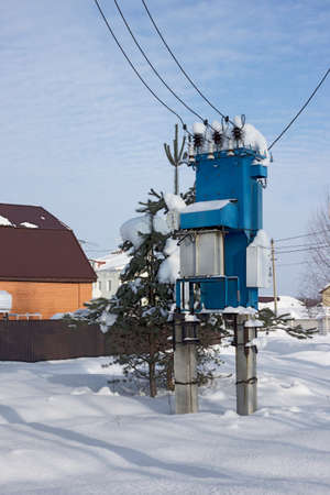 Rural transformer substation after a snowfall on the edge of the village