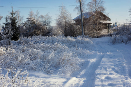 Snow rut on the outskirts of the village on a frosty winter evening. December. Russiaの写真素材