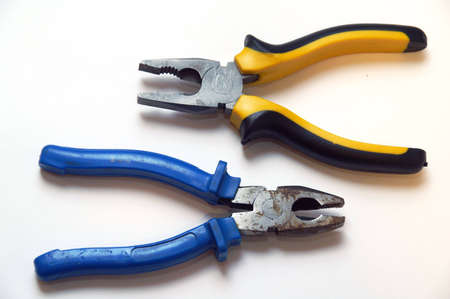 The new and old pliers on the white tableの写真素材