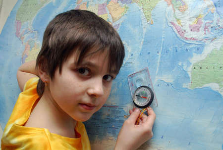 The girl and compass at the mapの写真素材
