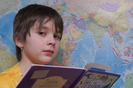 The girl with a book at the map of worldの写真素材