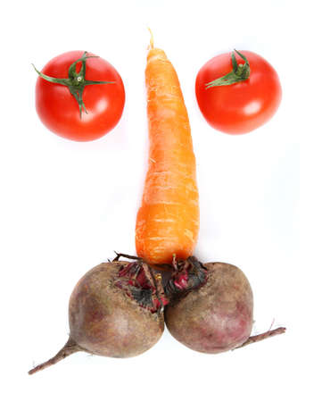 Three big  fresh  carrots, two tomatoes  and two beets on the  tableの写真素材