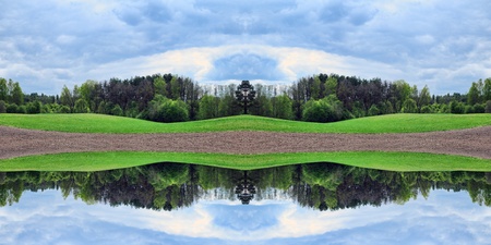 Rural landscape with green hills, forest and cloudy skyの写真素材
