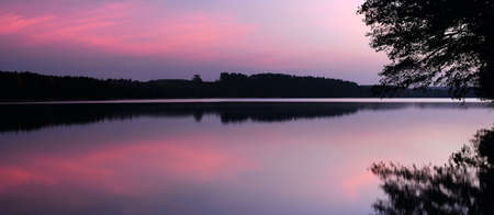Sunrise over the lake   Gentle colors of a dawn in the cold autumn morningの写真素材