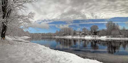 Winter landscape, cloudy sky reflection in river waters. Neris river, Lithuaniaの写真素材