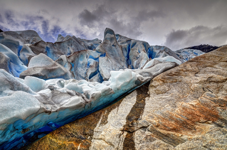Nigardsbreen glacier moving, moving clouds, moving water. Nigardsbreen glacier, a beautiful arm of the large Jostedalsbreen glacier.の写真素材