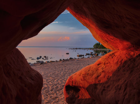 Sunset at the Gulf of Riga, view from the grotto. No waves, no wind. Tranquility atmosphere. Summer evening.の写真素材
