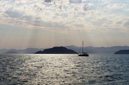Yacht in a sea on a background islands