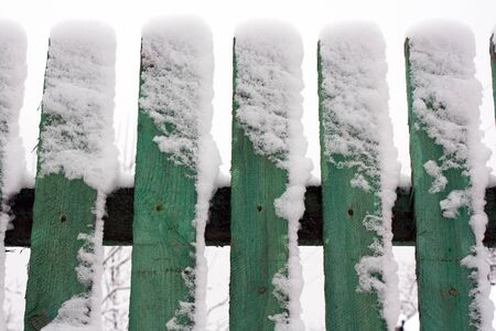 Wooden fence away in to snowの写真素材